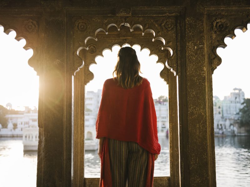 Western woman standing on a cultural architecture in Udaipur, India